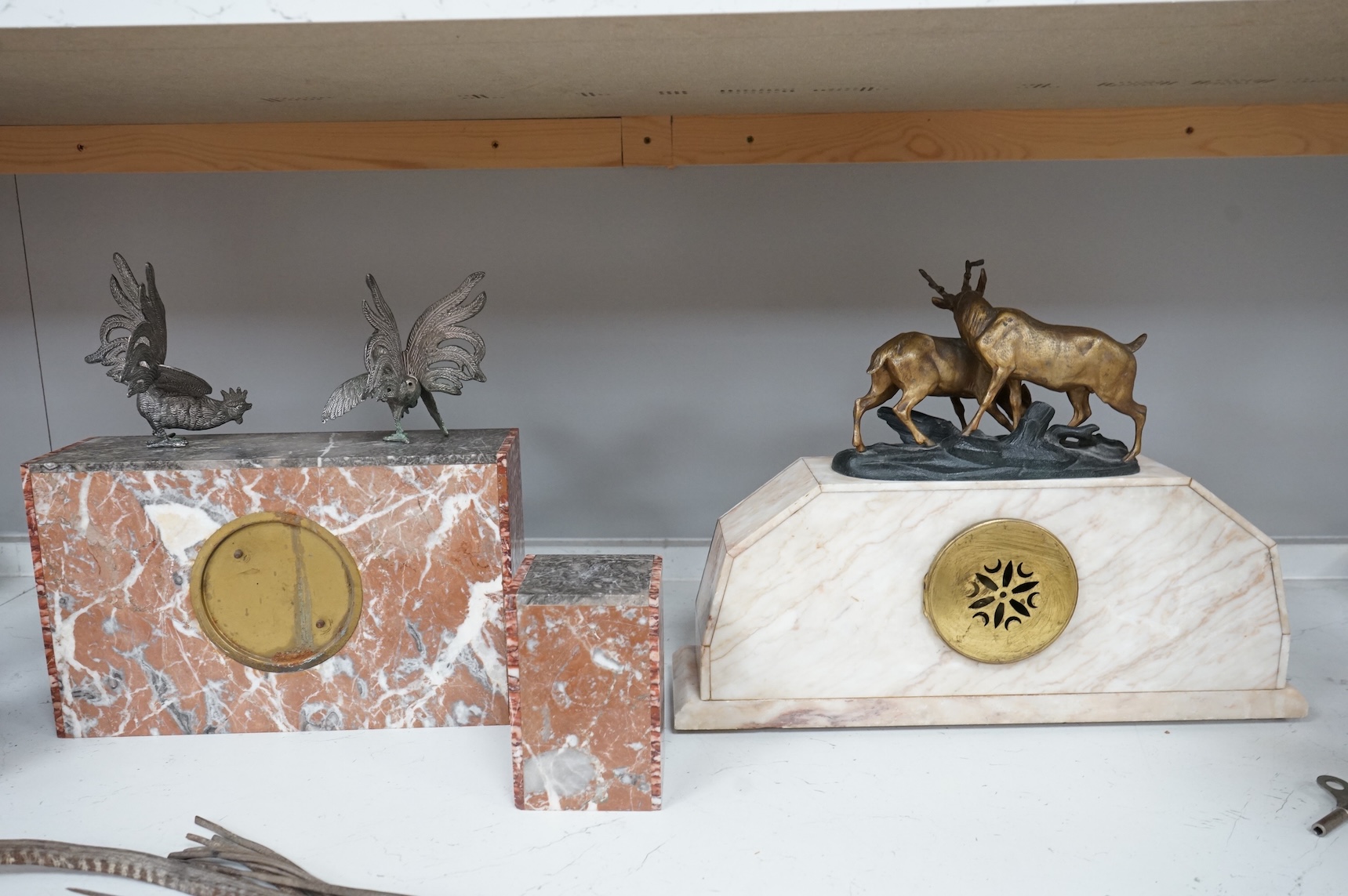 An Art Deco marble clock garniture and a French clock surmounted with two deer, with key, 44cm wide